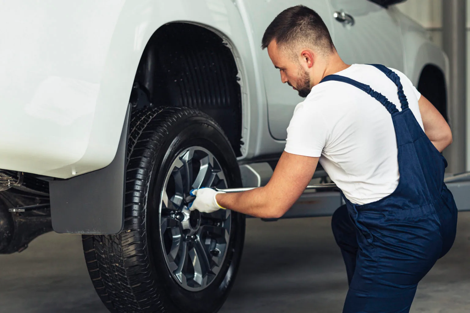 Male mechanic working on a car